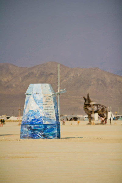 The Dutch CORE windmill turns by The Coyote. The painted panels brought overseas by the team are striking against the colors of the playa. 