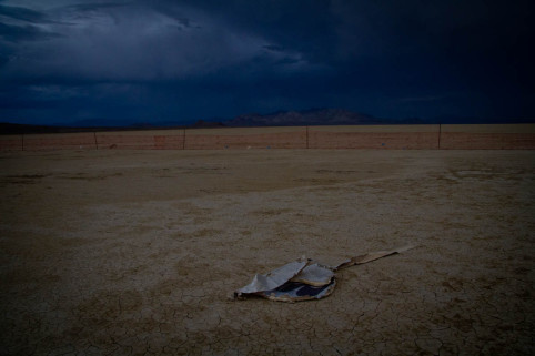 A piece of broken hexayurt by the trash fence