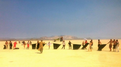 Robot Heart participants doing a line sweep after a mobile party in the open playa