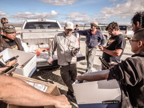 Armed with boxes, bags and GPS units, the inspection teams are briefed by the BLM.