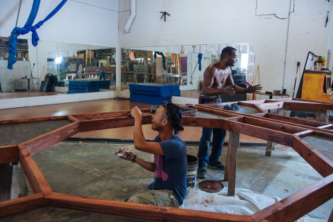 Edward “Shinobi” White (right) leads a team in hand-painting Mazu’s woodwork, with assistance from Bowen Chou, an artist and event producer from Taiwan.