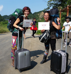 Welcome home! Megan and Iris pause in their uphill walk to the Gate after being greeted by Japan Regional Contact Makibee (on the right) and volunteers. Photo by Iris Yee.