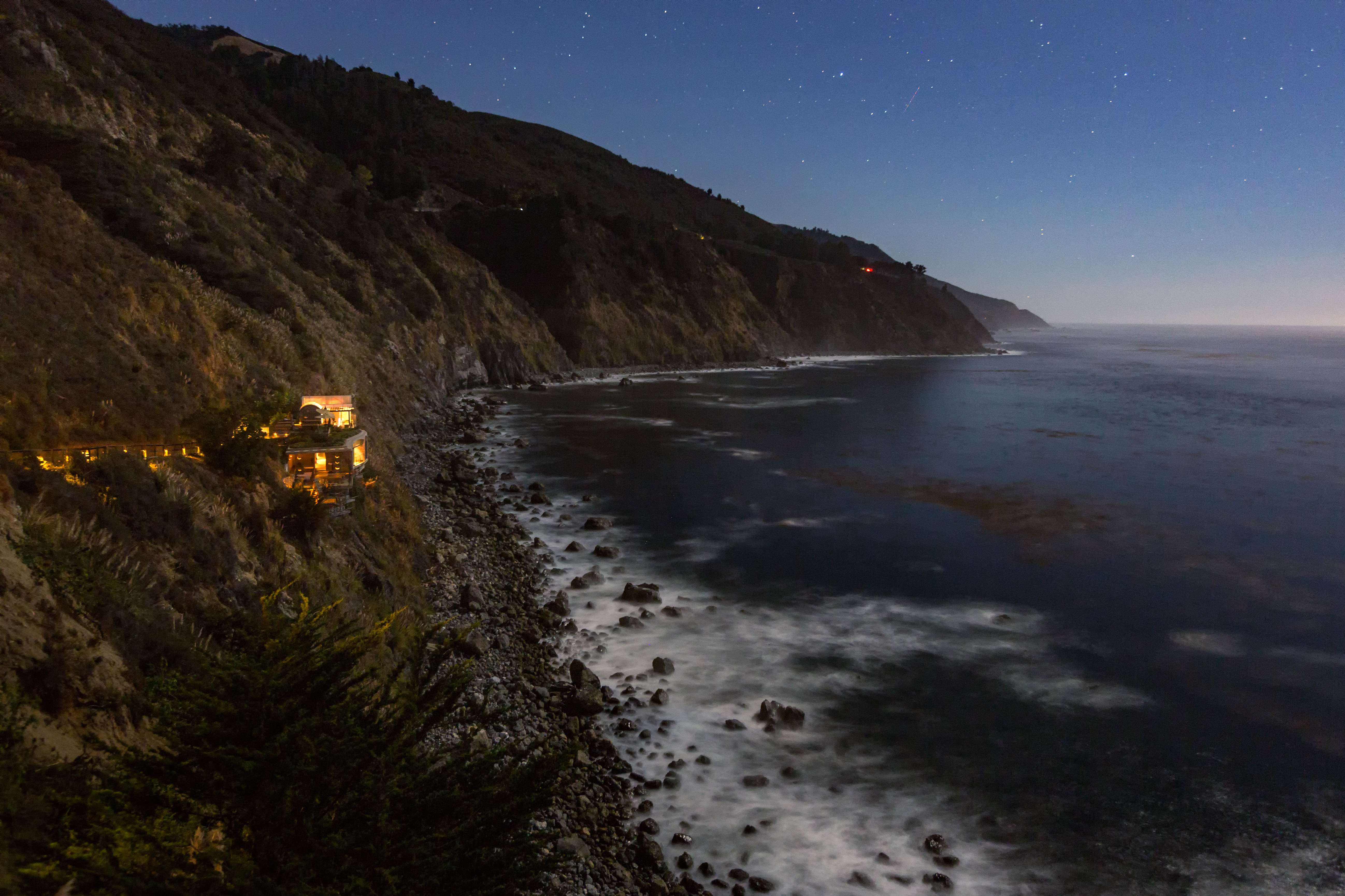 The cliffs at night, and the baths glowing on the edge of the cliffs