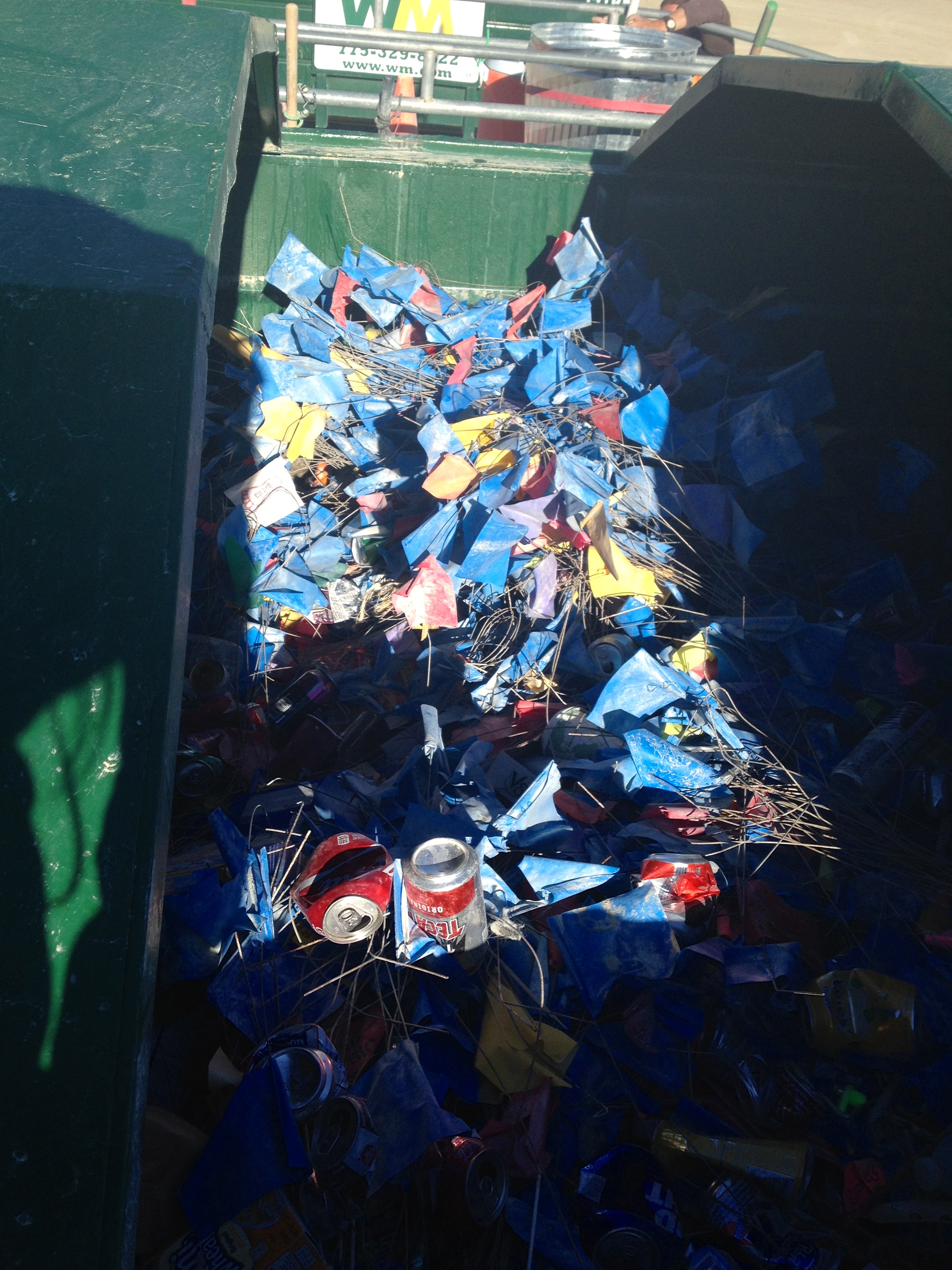 These are the placement flags, piled neatly in Resto's commingled recycling dumpster. As the Line Sweep crews advance over blocks, they take the flags, signifying the camp's been swept and scribed.