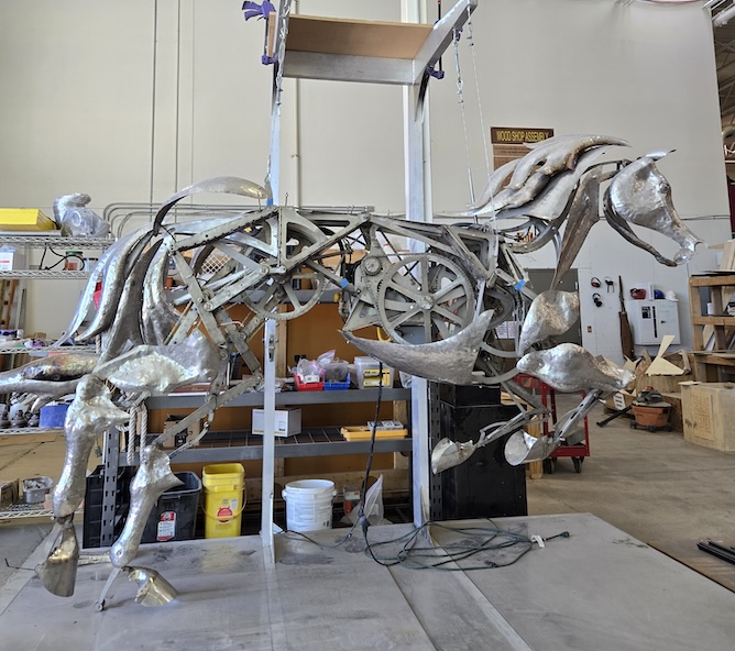 Artist Adrian Landon works on a piece at The Reno Generator