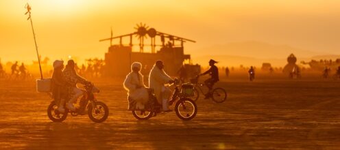 Bikes cruise the playa at sunset (Photo by Espressobuzz)