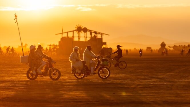 Bikes cruise the playa at sunset (Photo by Espressobuzz)