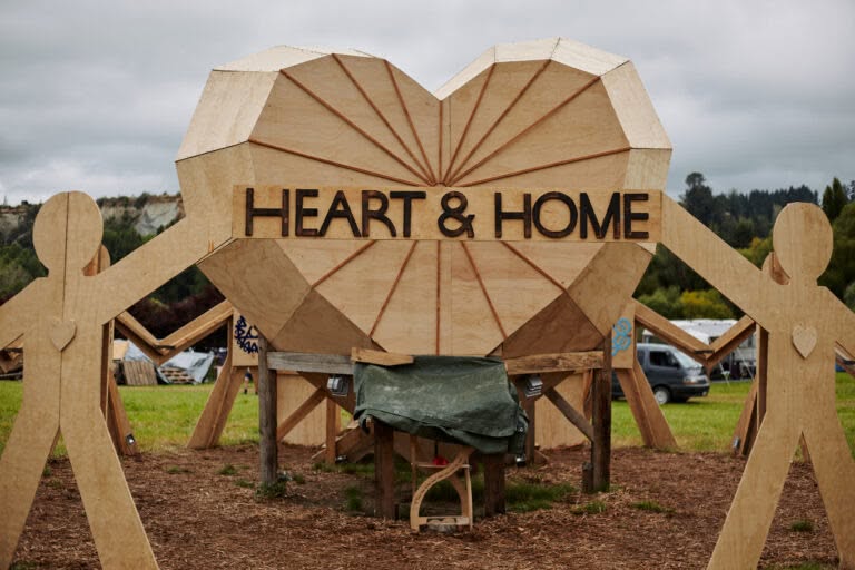 Wooden 3D heart shape with radial lines running from edge to center. The words "Heart and Home" stretch across the middle.